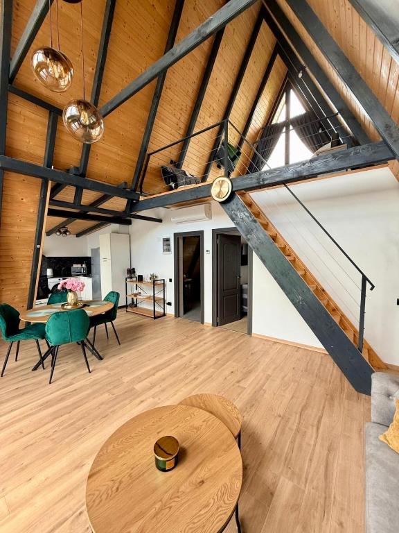Interior open-plan cu tavane înalte și scară spre mansardă